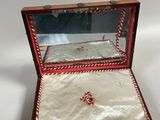 an old wooden box with a mirror on top of it