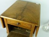 a small wooden table with a drawer underneath it