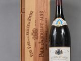 an image of a bottle of wine next to a wooden box