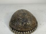 an old metal box with skulls on it sitting on a white surface