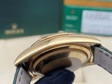 a person holding a watch in their hand with a box in the background