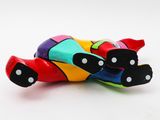 a figurine of a colorful cat laying on the ground