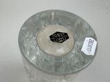 a glass vase with a label on it sitting on a table