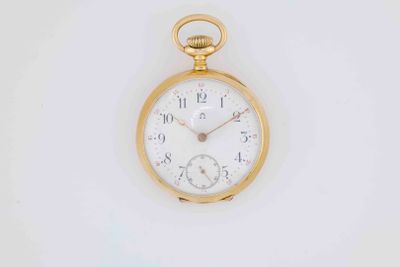 a gold pocket watch with a white face on a white surface