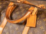 a close up of a brown and tan louis vuitton bag