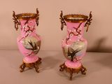 two vases that are sitting on a table