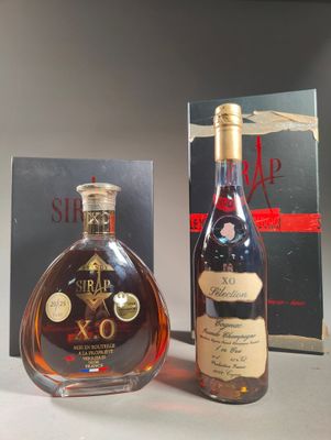 two bottles of brandy are sitting next to a box of wine