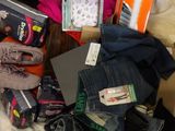 a suitcase full of clothes and other items on a bed
