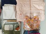 a bag of clothes, shoes, and a bag of clothes on a table