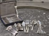 silver spoons and spoon spoons sitting on a table