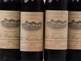 six bottles of wine are lined up in a row on a table