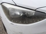 a close up of a car ' s headlight on the side of the road