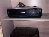 a small shelf with a printer and other electronics on it