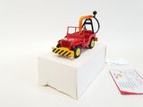a red toy tractor on a white box with a tag