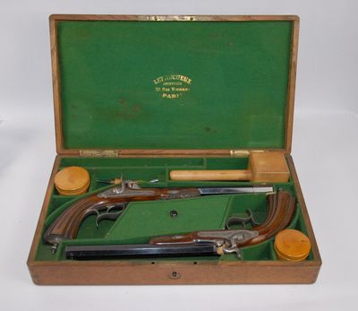 a wooden case with two guns inside of it
