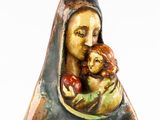 a figurine of a woman holding an apple