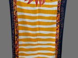 a yellow and white striped towel with a sun on it
