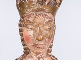 an old statue of a woman with a crown on her head