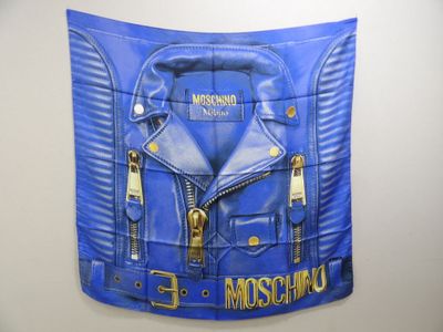 a picture of a blue moschino jacket hanging on a wall
