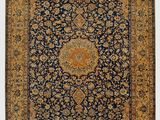 an antique persian rug with blue and gold colors