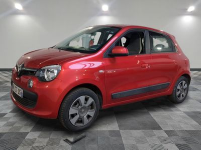 the small red car is parked in the garage on a checkered floor