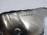 a silver pitcher that is sitting on a table