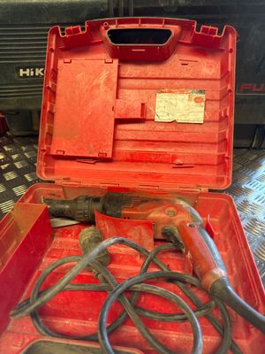 a red tool box with tools in it on a table
