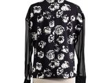 a black and white floral shirt with sheer sleeves on a mannequin dummy