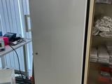 a white refrigerator in the corner of a room