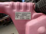 someone is holding a pink spray can with a sticker on it