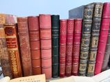 many old books sitting on a table next to each other