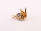 an image of a gold pocket watch on a white surface