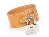 a close up of a leather bracelet with a padlock on it