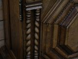 a close up of a wooden door with a clock on it