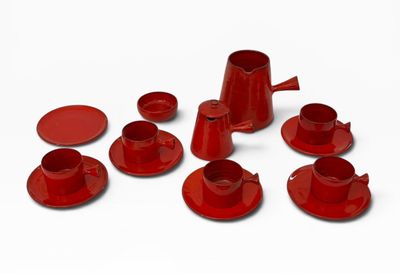 beaucoup de tasses et soucoupes rouges sur un fond blanc