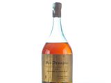 an old bottle of whiskey sitting on top of a white surface