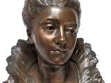 bronze bust of a woman with curly hair and a frillying collar