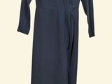 the dress is black and has long sleeves and a v - neck