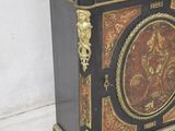 a black and gold cabinet with a marble top