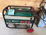 a small green and white generator sitting on a cart