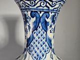 a blue and white vase sitting on a table