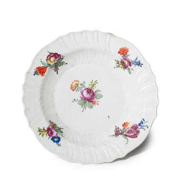 a close up of a plate with flowers on it on a white surface