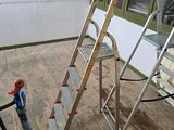 a small hand truck with a ladder on the floor