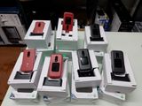 many cell phones that are sitting in boxes on a table