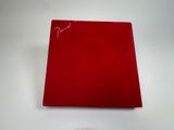 the red book is sitting on a white table with a clock on it