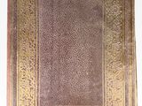 an old book on a white surface with a gold border