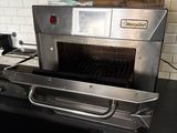 a silver oven sitting on top of a counter in a kitchen