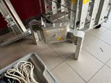 a metal cart with a rope in it on the floor