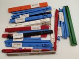 a lot of different colors of paper clips on a table