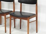 pair of mid century danish teak dining chairs with black leather upholstered seats